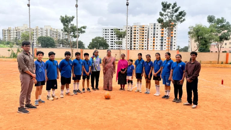 Principal Mrs. Alexandra Thangam encouraging students at the football event, reflecting excellence among schools in Hosur.